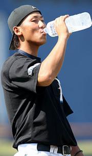 練習中、豪快に水を飲む日本ハムの中田