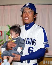 病院を慰問した井端は子供を抱いて記念撮影(撮影・清水貴仁)