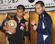 調印式を終えファイティングポーズをとる榎(右)とクリス・ジョン