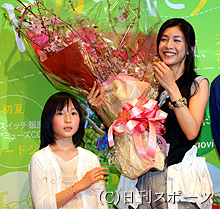 子役の松本花奈(左)から桜の花束をプレゼントされ笑顔を見せる竹内結子