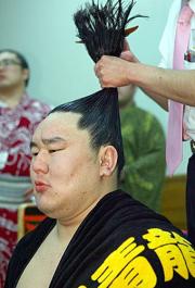 髪を直してもらう朝青龍の表情は険しい（撮影・鈴木豊）
