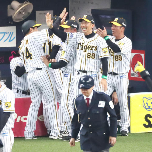 サヨナラで1勝目を挙げた矢野監督は笑顔でコーチ陣とハイタッチする（撮影・加藤哉）