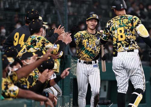 阪神対中日　5回裏阪神1死二、三塁、糸原の内野ゴロで生還しナインとハイタッチする坂本（右から2人目）（撮影・上田博志）