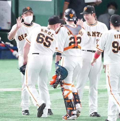 巨人対中日　8回無失点で勝利投手の巨人菅野（右）はクロール（左手前）らナインを迎える。左は原監督（撮影・鈴木みどり）