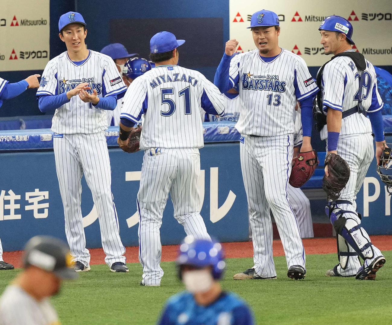 DeNA対阪神　7回表を無失点に抑え、伊勢（右から2人目）はナインをベンチ前で迎える。左は大貫（撮影・鈴木みどり）
