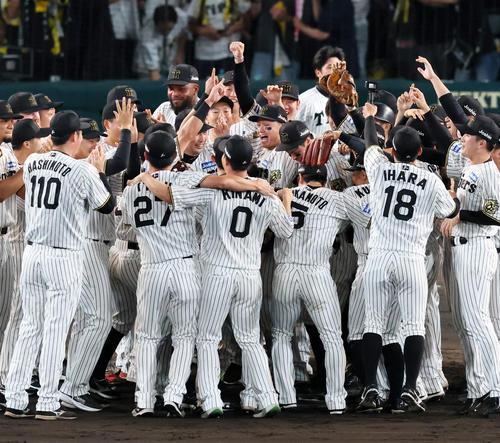 阪神対広島　リーグ優勝を決め輪の中で笑顔を見せる森下（左）と佐藤輝ら阪神ナイン（撮影・加藤哉）