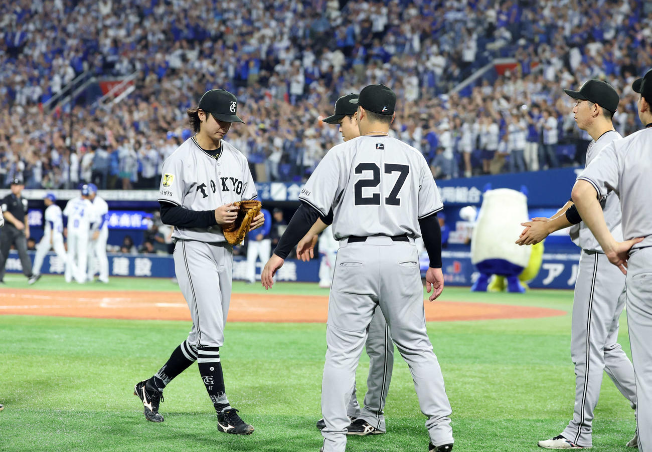 DeNA対巨人　11回裏DeNA2死一、三塁、蝦名にサヨナラ適時打を許した田中瑛（左）はナインに迎えられ、がっくり引き揚げる（撮影・浅見桂子）