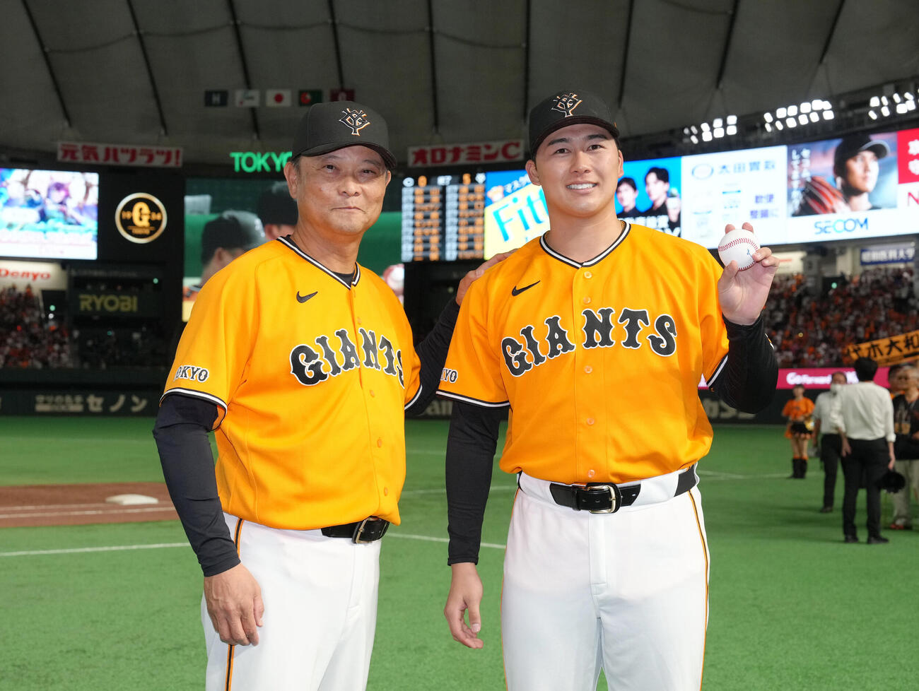 巨人対広島　プロ初勝利を挙げた巨人代木大和（右）は橋上秀樹監督代行と笑顔で記念撮影（撮影・足立雅史）