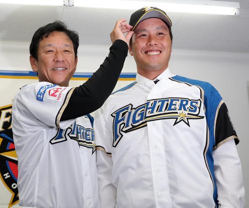 ロッテから移籍し、入団会見で笑顔を見せる日本ハム藤岡貴裕と栗山監督(2018年7月27日撮影)