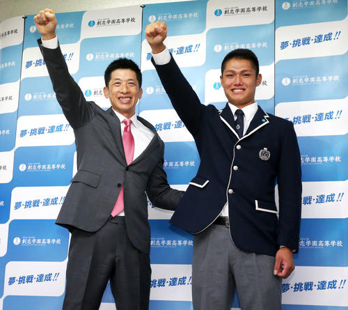 指名のあいさつに訪れた阪神矢野監督（左）と一緒にガッツポーズを見せる創志学園・西純矢（2019年10月18日撮影）