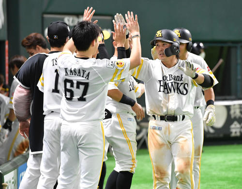 ソフトバンク対ロッテ　7回裏ソフトバンク2死一塁、左中間へ勝ち越しの2点本塁打を放ち、ナインとタッチを交わす甲斐（撮影・岩下翔太）
