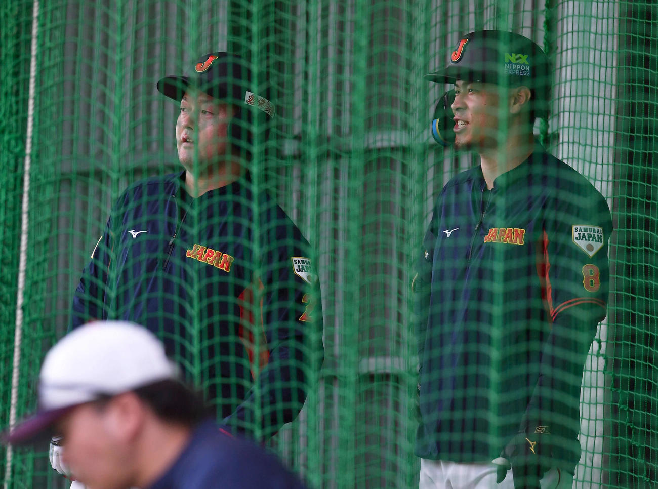 11月13日、ブルペンで投球する桐敷を見つめる牧（左）と佐藤輝