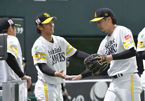 ソフトバンク対阪神　7回途中無失点で降板となり、今宮（左から2人目）らナインとタッチを交わしてベンチへ戻る東浜（撮影・岩下翔太）