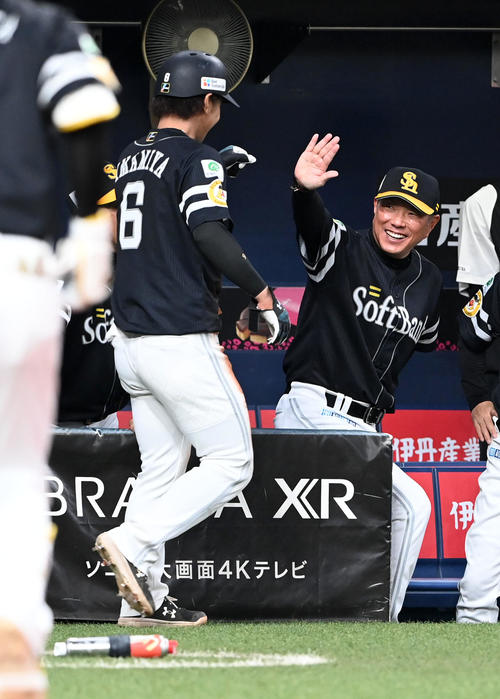 オリックス対ソフトバンク　1回表ソフトバンク1死三塁、柳田の先制右犠飛で生還した今宮（左）を笑顔で迎える小久保監督（撮影・前岡正明）