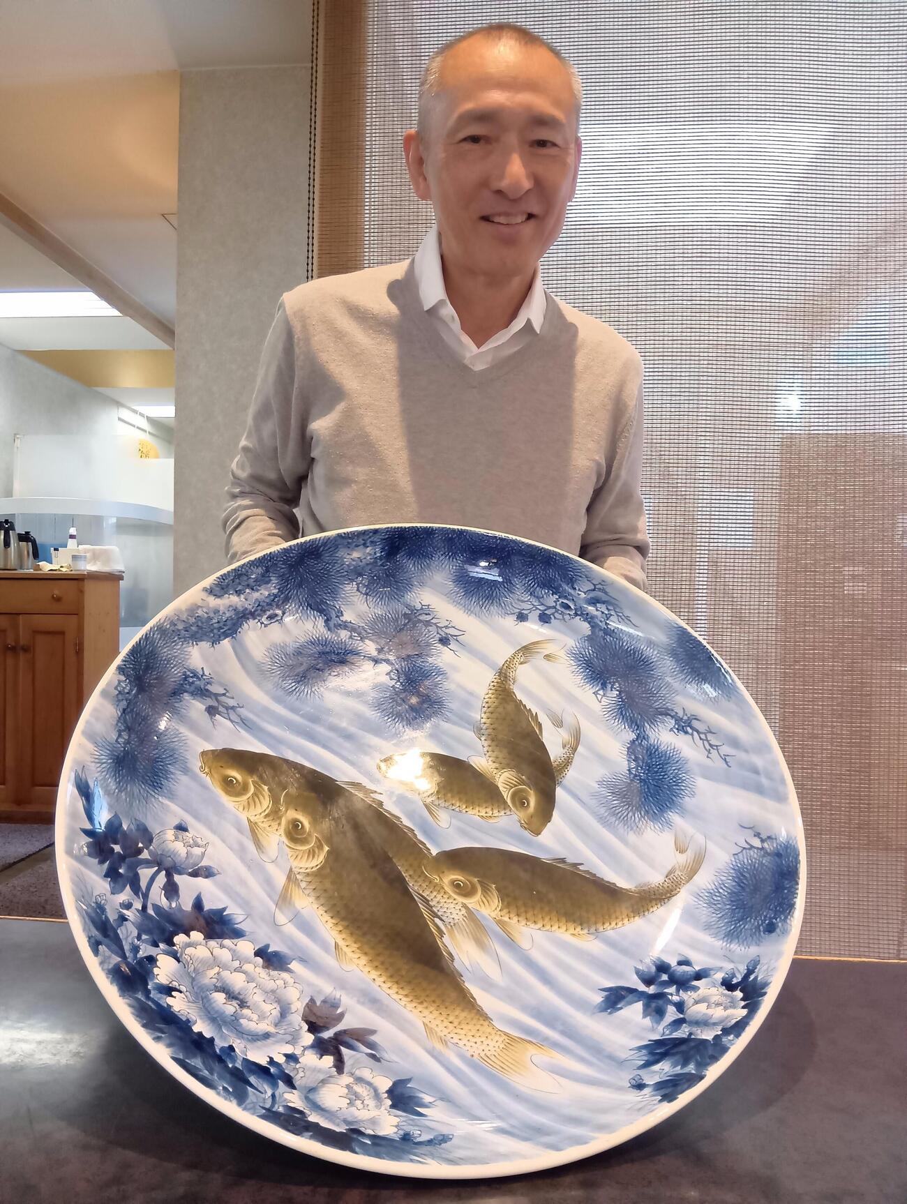 長嶋さん来店時に使用した有田焼の大皿とオーナーの河野暢公（のぶまさ）さん（撮影・沢田啓太郎）