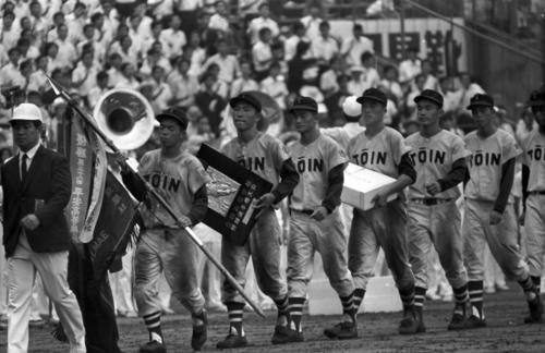 ７１年８月、優勝旗を持つ小島和彦主将を先頭に場内を１周する桐蔭学園ナイン。優勝盾を持つのは土屋恵三郎捕手