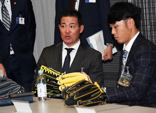 ミズノブランドアンバサダーズミーティングでグラブを手に取る阪神福留孝介（左）と高山俊（2017年12月8日撮影）