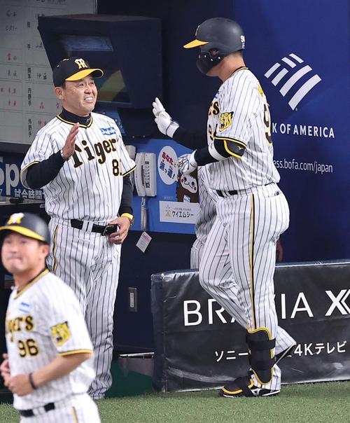 阪神対DeNA 8回裏阪神2死二塁、岡田監督（左）は左越え2点本塁打を放った原口をパータッチで出迎える（2023年4月2日撮影）