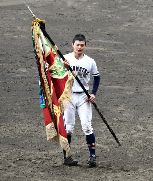 準優勝旗を受け取った高松商・米麦圭造主将（2016年3月31日撮影）