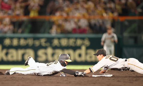 阪神対巨人　12回裏阪神1死一塁、二盗を狙うもオーバーランし、湯浅（右）にタッチアウトされる島田（撮影・狩俣裕三）