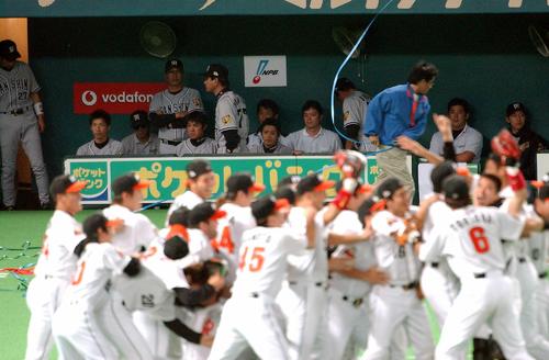 喜ぶダイエーナインを尻目にそそくさと引き揚げる阪神・星野仙一監督（中奥）（2003年10月27日撮影）