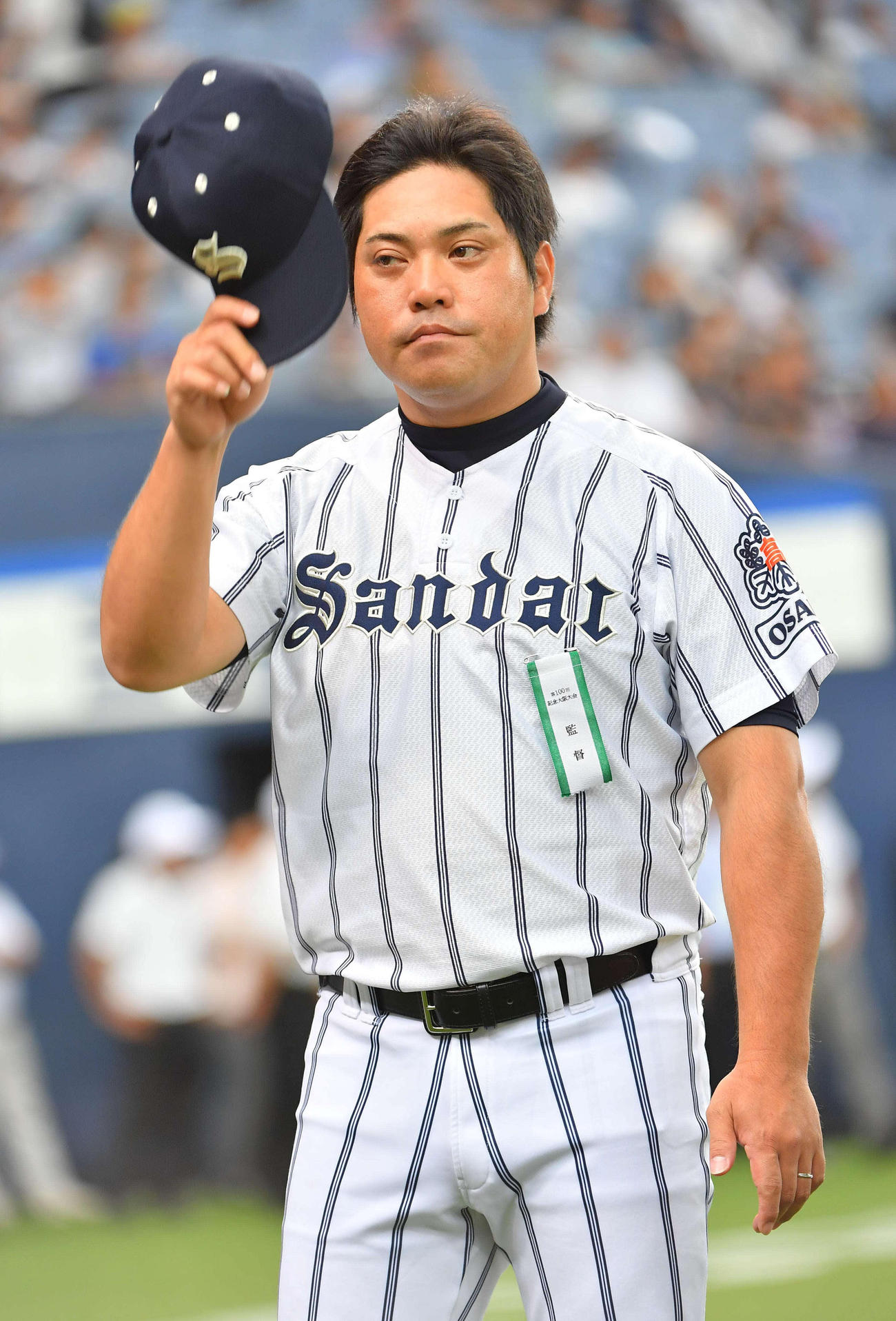 帽子を取って応援団にあいさつする大産大・田上秀則監督（撮影・上田博志）