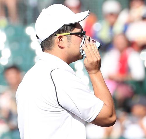 広陵対二松学舎大付　レジェンド始球式で投球後、ハンカチで顔を拭く本間篤史氏（撮影・白石智彦）