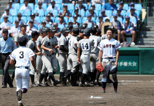 山梨学院対熊本工　12回裏熊本工1死、山口にサヨナラ本塁打を浴び、喜ぶ熊本工ナインを背に悔しそうな表情で立ちつくす山梨学院・相沢（手前右）（撮影・前田充）