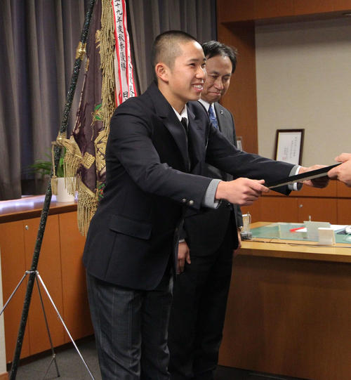 表彰状を笑顔で受け取る主将の阿部投手。右は加藤校長