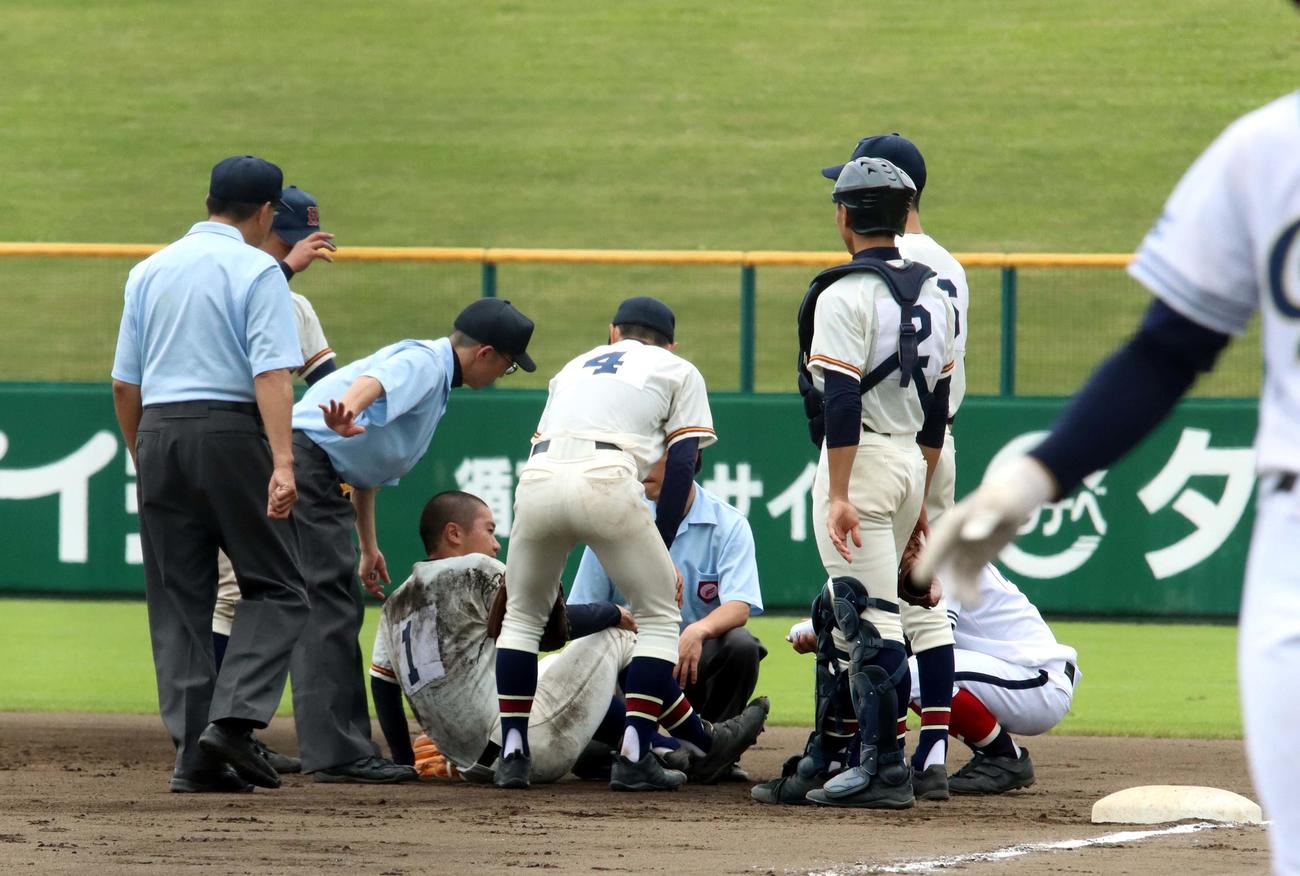 本別対帯広大谷　6回裏帯広大谷2死、一塁ベースカバーに入った本別の斉藤投手が右膝を痛め倒れ込む（撮影・永野高輔）