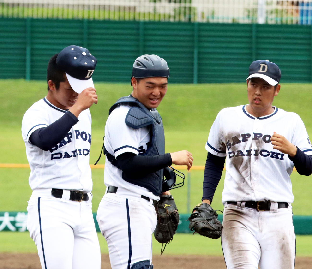 5回コールド勝ちで南大会出場を決め、小学校時代からバッテリーを組む札幌第一の山田（左）に笑顔で話しかける布施（中）（撮影・永野高輔）