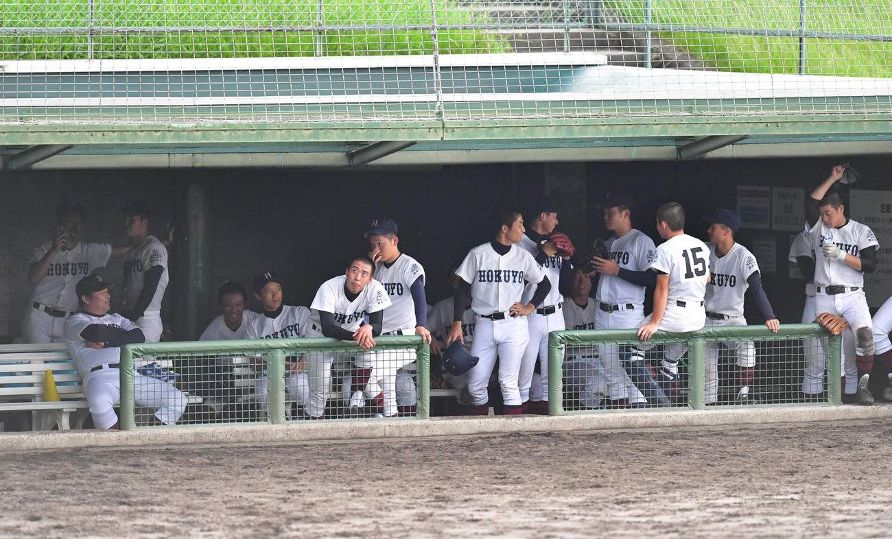 星翔対関大北陽　6回表星翔1死、球場周辺の空に雷曇がかかり試合が中断され、ベンチに避難した関大北陽ナイン（撮影・岩下翔太）