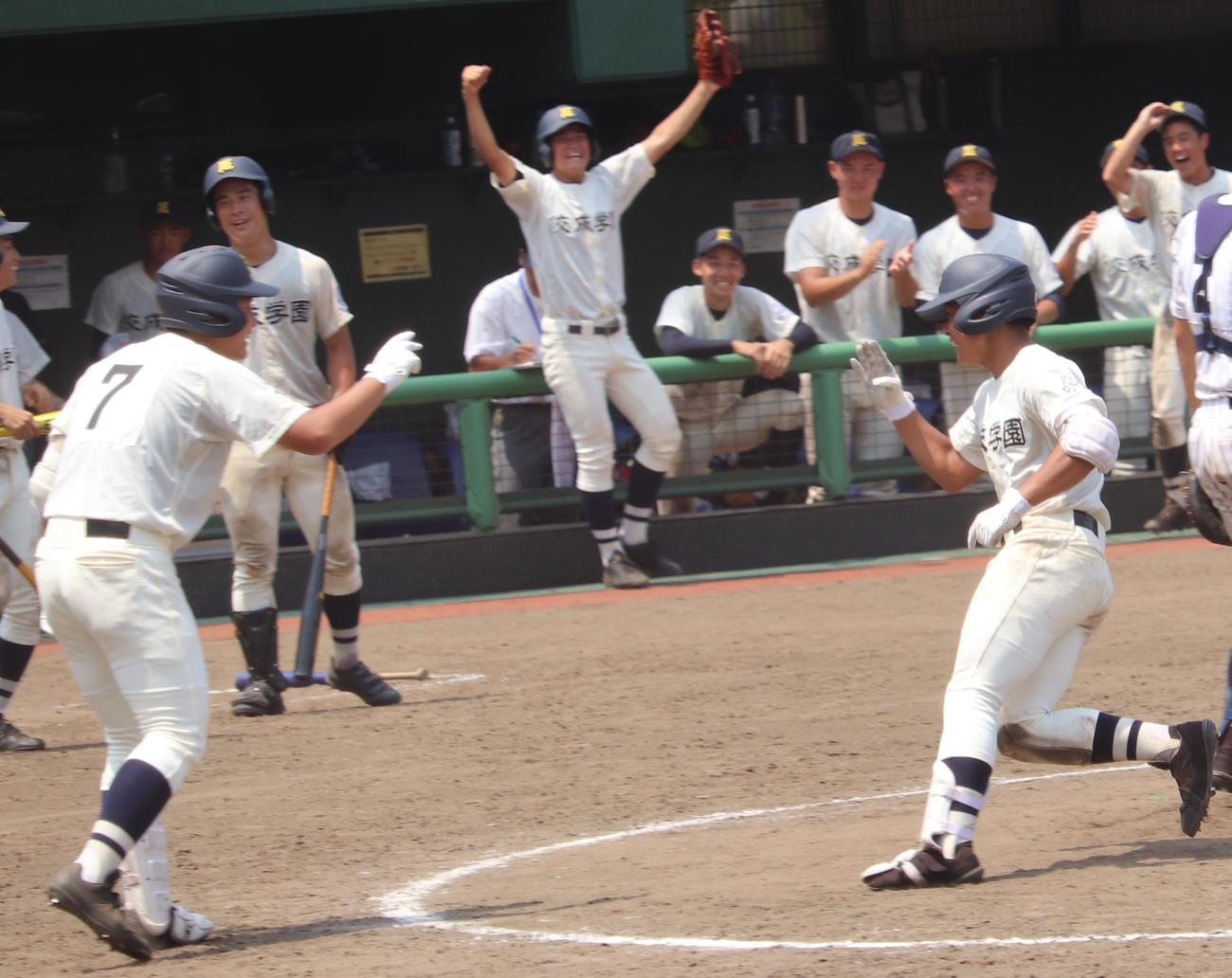 佼成学園対国士舘　9回表佼成学園無死、左中間へ決勝のソロ本塁打を放ち生還する佐藤（右）（撮影・古川真弥）