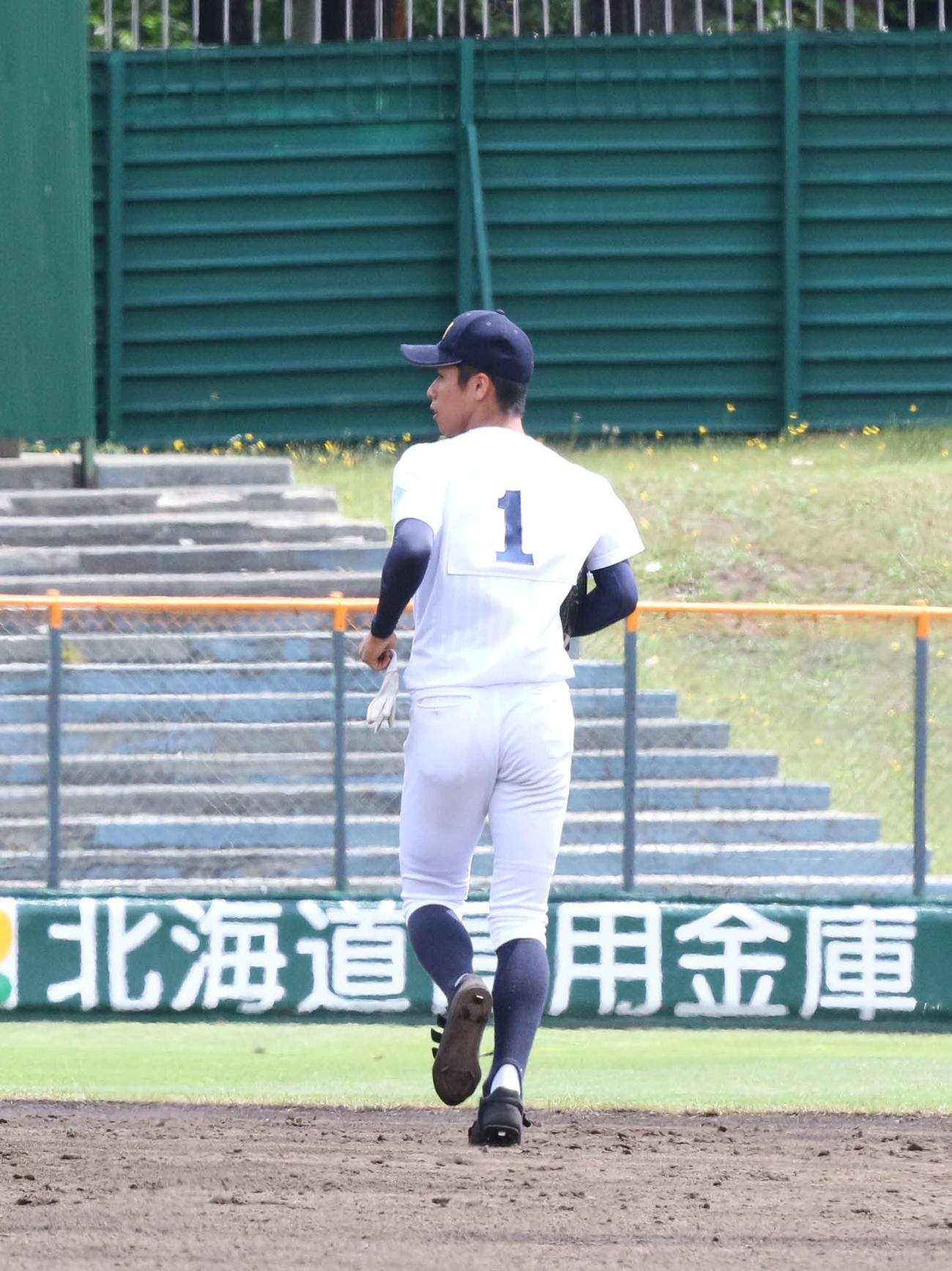 札幌第一対札幌国際情報　5回表札幌第一1死、高木を左飛に打ち取った段階で1週間500球の球数制限を超えて降板した札幌国際情報先発の原田は左翼の守備位置に向かう（撮影・浅水友輝）
