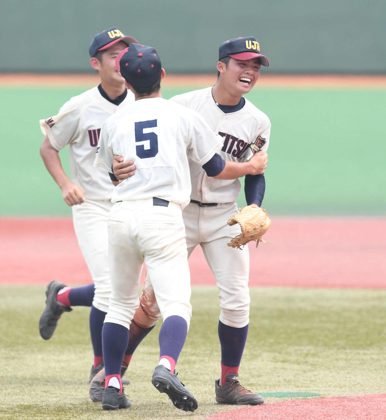 浦和実対埼玉栄　タイブレークの末に勝利した浦和実・豆田（右）はチームメートと抱き合って喜ぶ（撮影・山崎安昭）