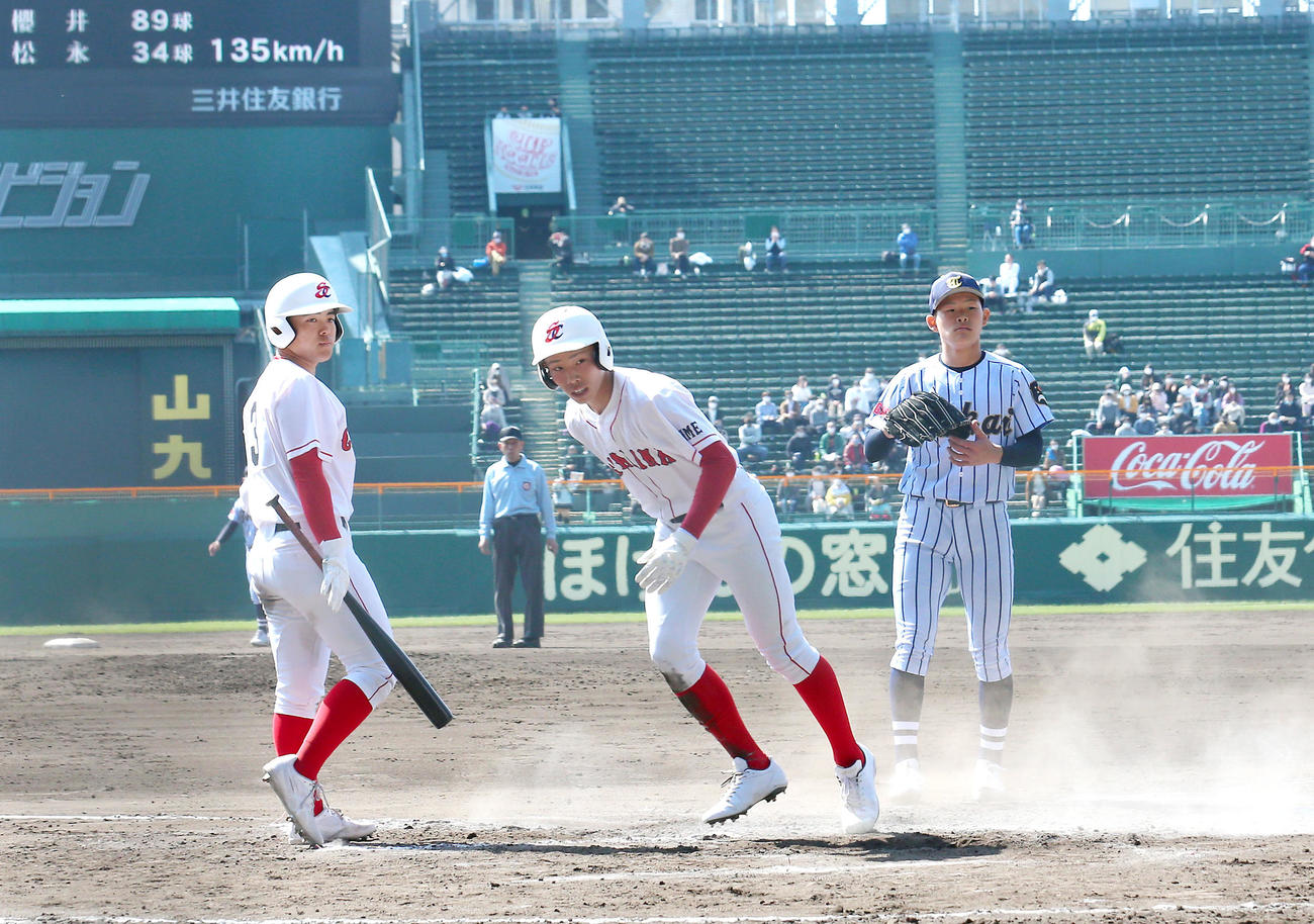 聖カタリナ学園対東海大菅生　7回表聖カタリナ学園2死、一、三塁、パスボールで三走井上（右から2人目）が生還する（撮影・上山淳一）