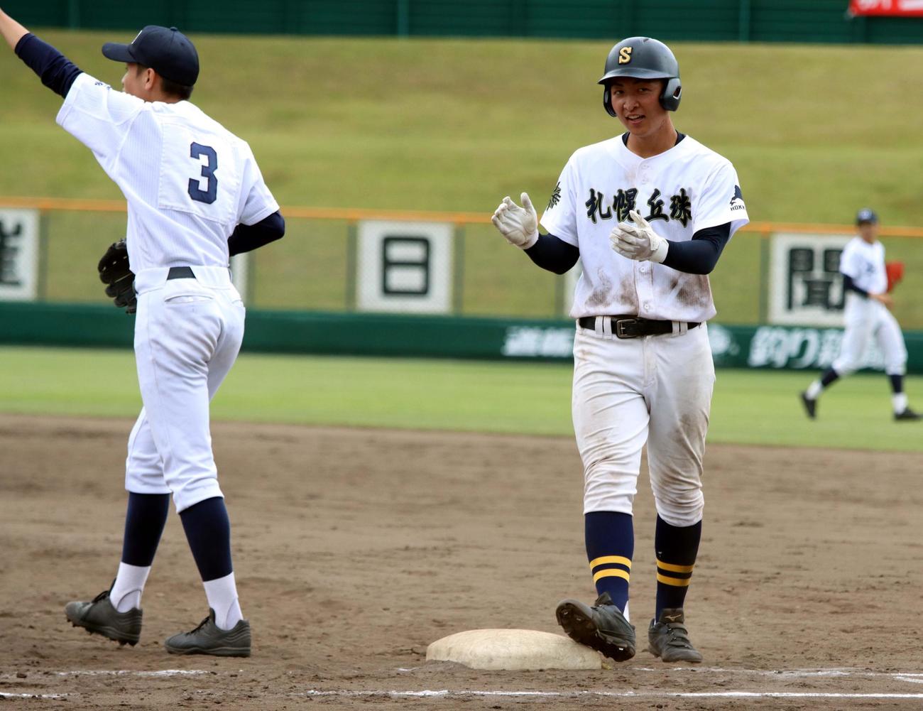札幌南対札幌丘珠　5回裏札幌丘珠1死満塁、佐々木寛が勝ち越しの左前2点適時打を放ち塁上で手をたたく（撮影・永野高輔）