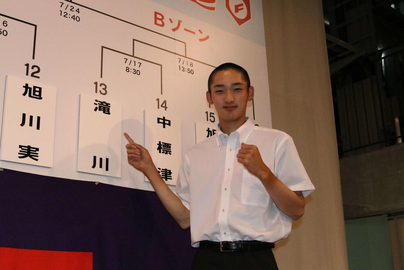 抽選会後、校名を指さす滝川の武曽主将（撮影・山崎純一）