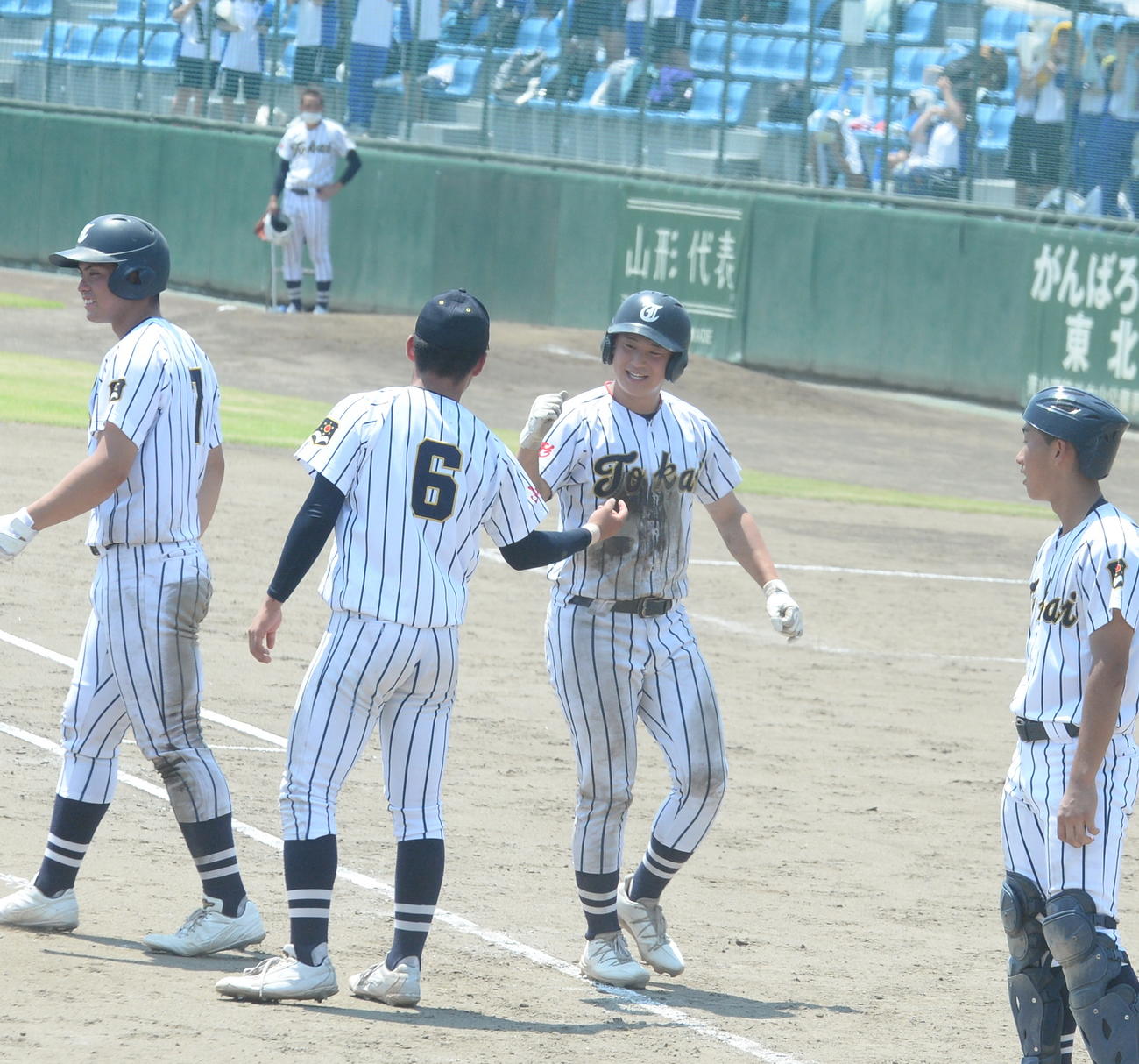5回2死三塁で中越え適時打を放ちコールド勝ちを決めた東海大山形・水尾（中央）（撮影・濱本神威）