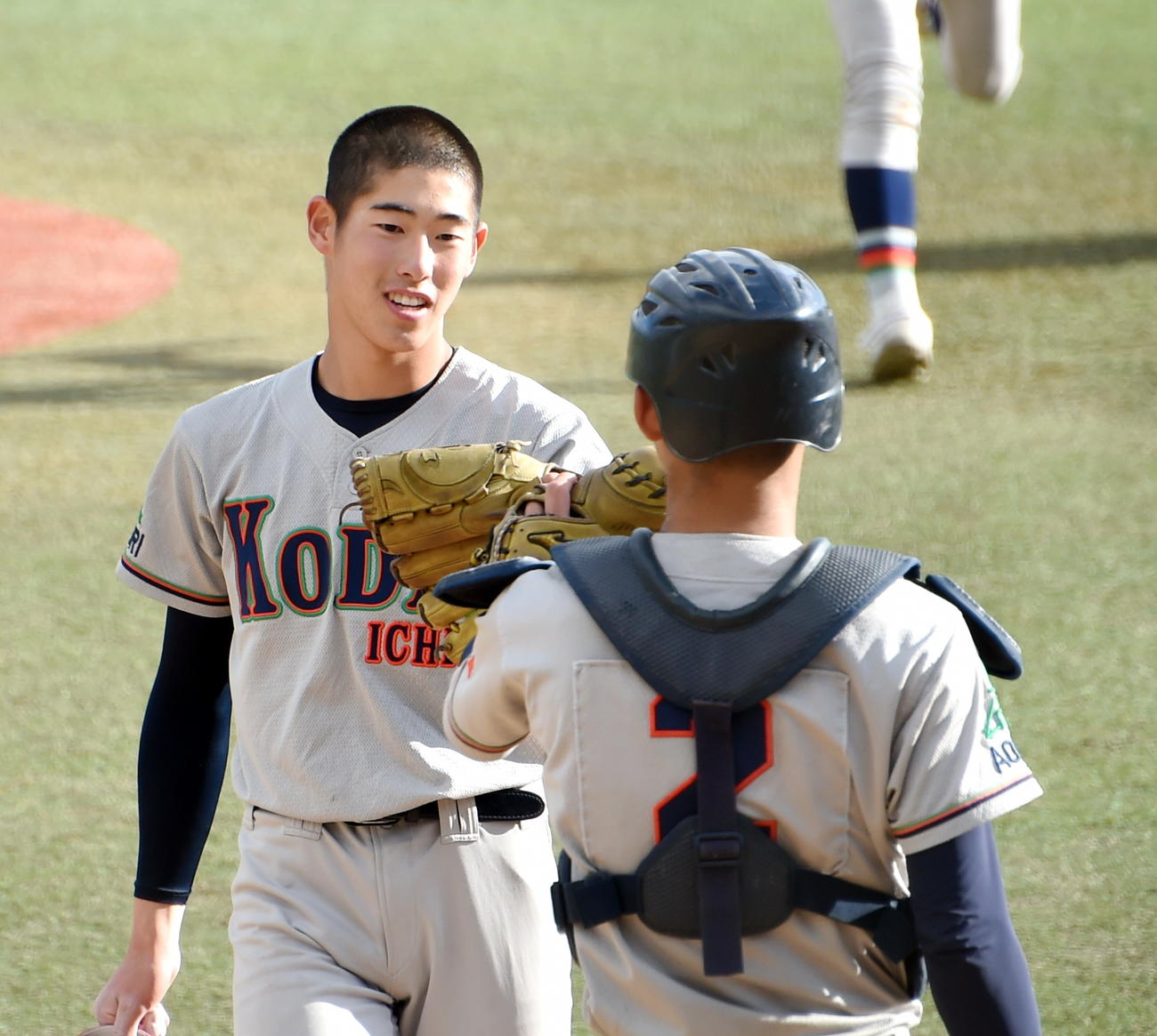 10月20日、酒田南に勝利し、グラブタッチする八戸工大一・広野（左）と葛西