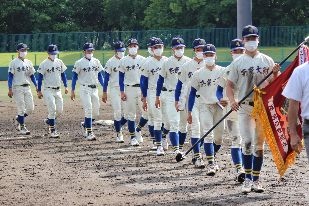 優勝旗を手に行進する奈良大付ナイン（撮影・柏原誠）
