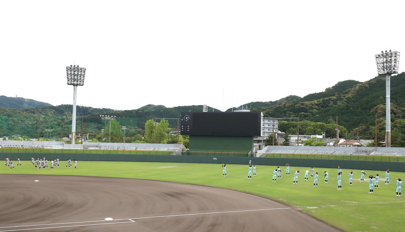 練習試合近江対京都国際　外野で練習を始める京都国際ナイン（左）と近江ナイン（撮影・白石智彦）＝2022年6月8日、マイネットスタジアム皇子山