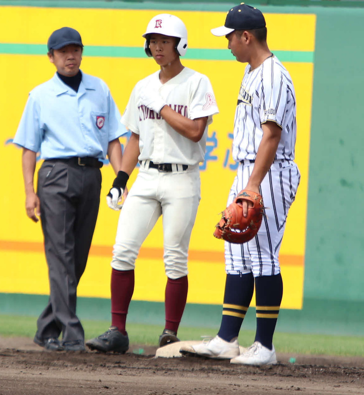 旭川大高対白樺学園　3回表旭川大高無死、中前打を放ち出塁する広川主将（中央）（撮影・山崎純一）