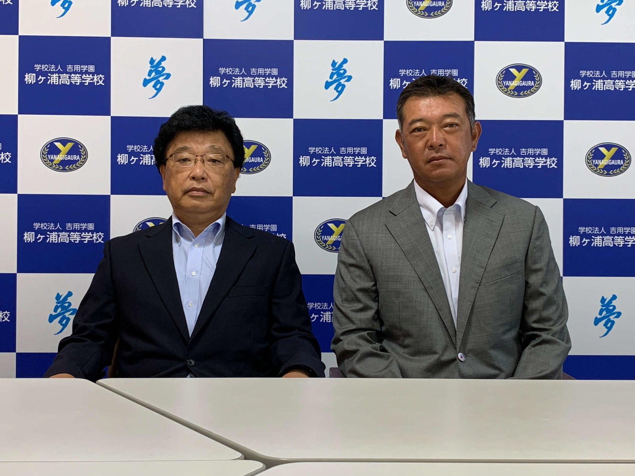 柳ケ浦の新監督を発表する佐藤扇太郎校長（左）と鈴木聡監督（学校提供）