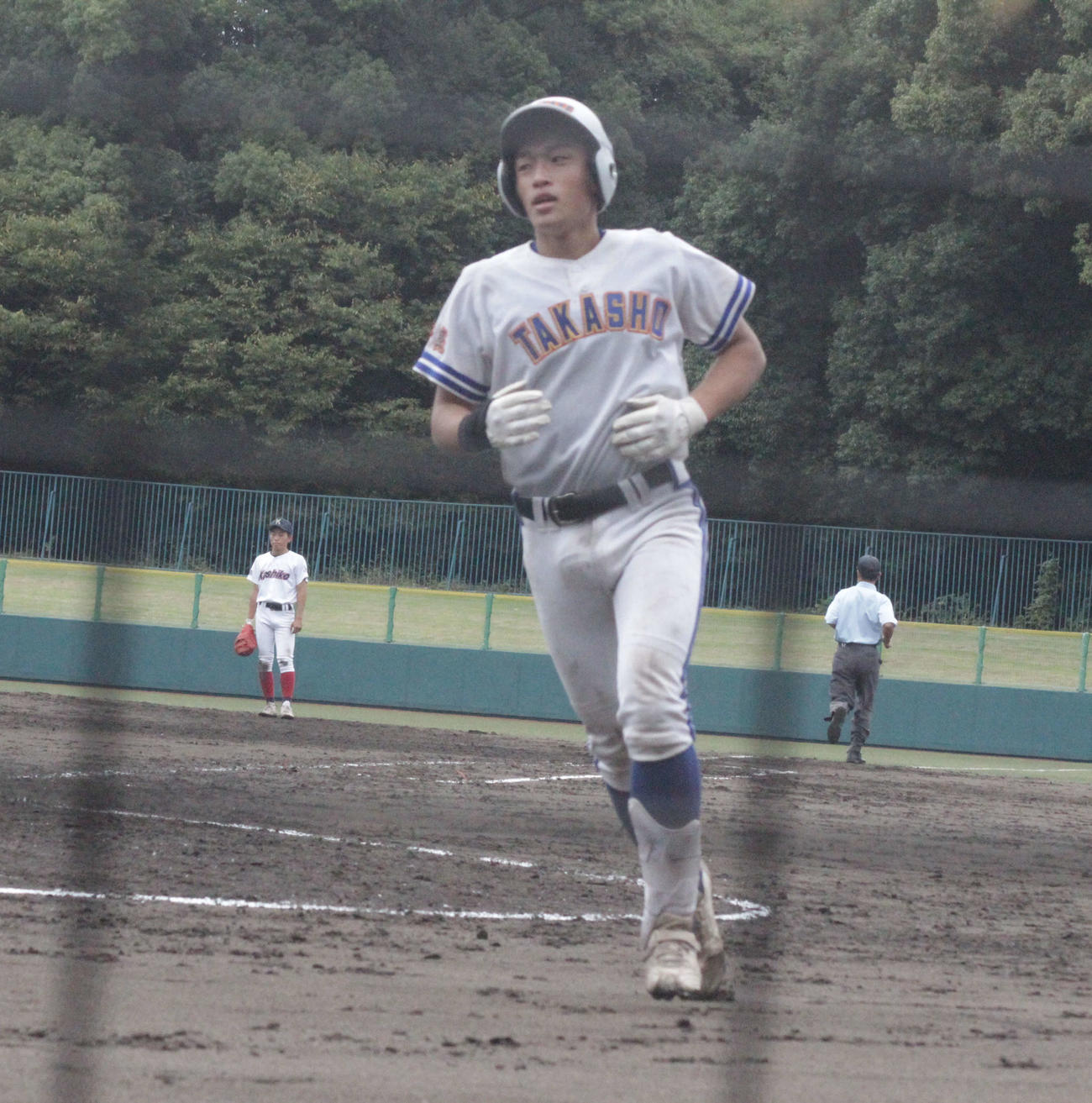橿原対高田商　高田商の北嶋悠輝捕手は5回、左翼に本塁打を放って生還した（撮影・酒井俊作）