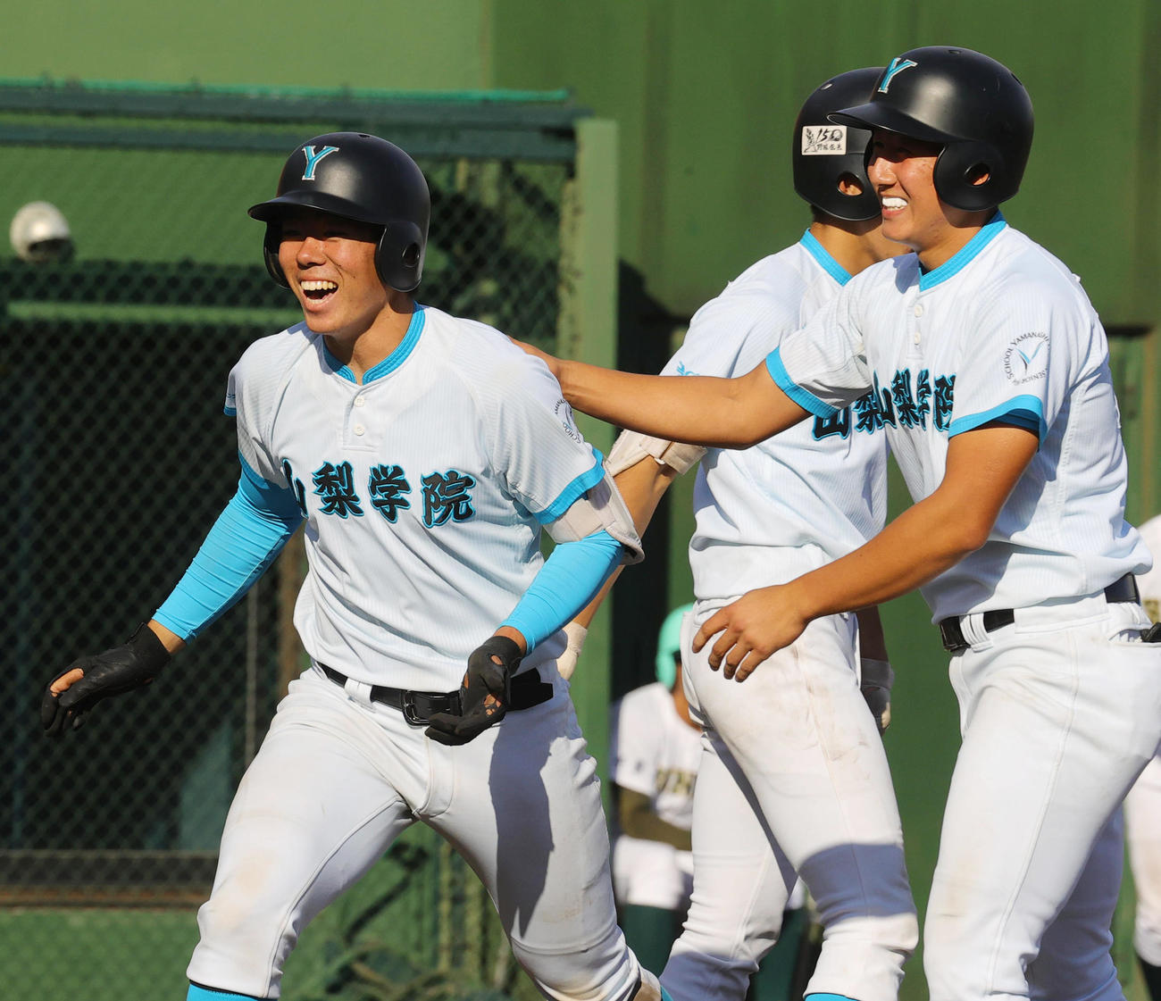 山梨学院対専大松戸　9回表山梨学院2死一、二塁、左越え3点本塁打を放った佐仲（左）は、前の打者で申告敬遠された高橋に迎えられ笑顔（撮影・野上伸悟）