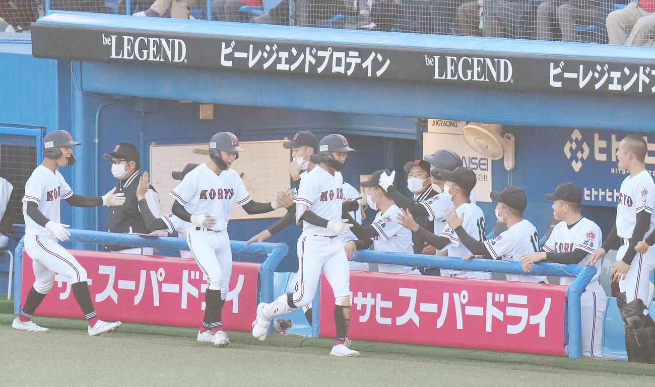 北陸対広陵　6回裏広陵無死満塁、左3点適時三塁打を放ち、相手の悪送球で生還した松下（中央）は、ナインにタッチで迎えられる（撮影・菅敏）