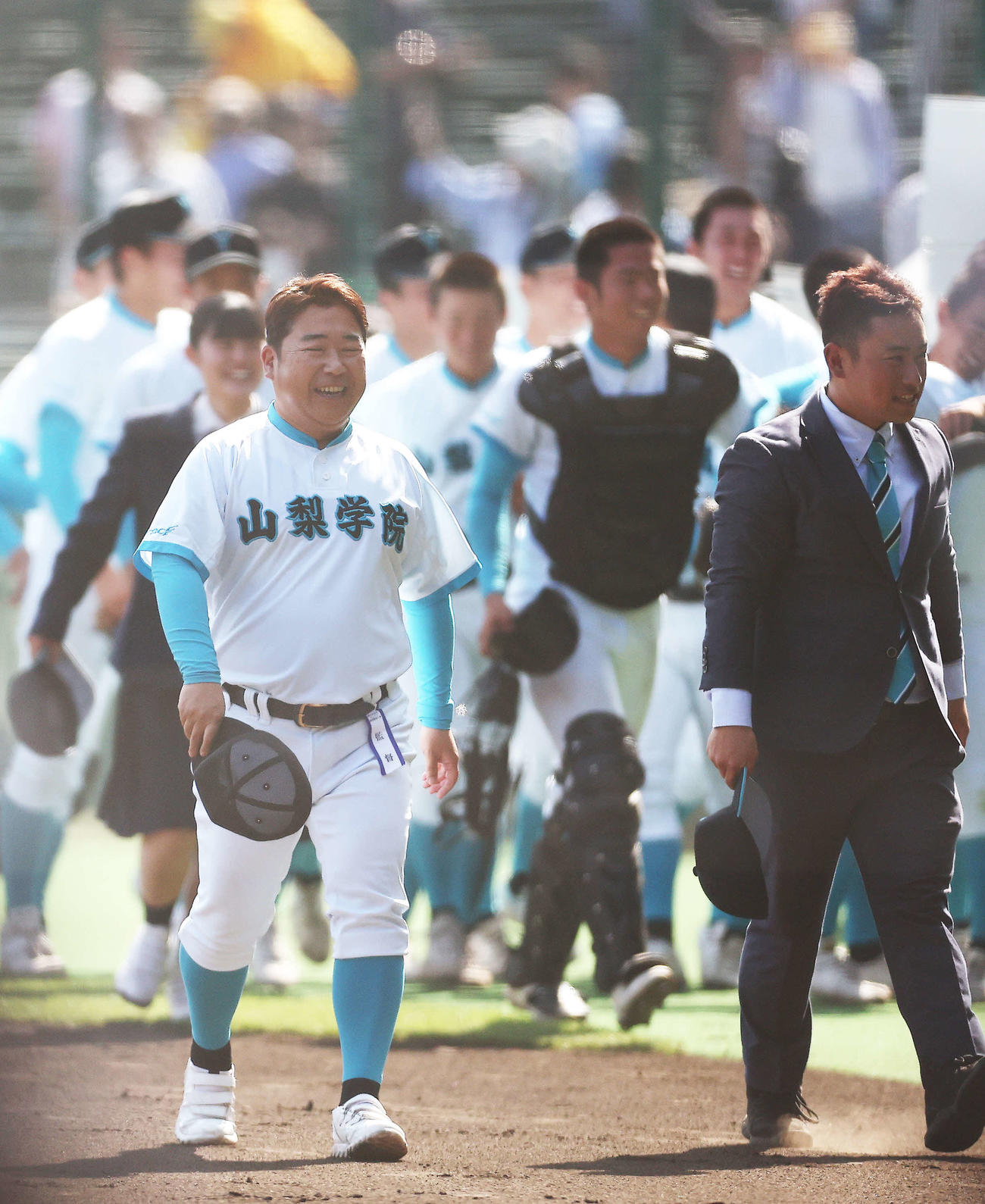 報徳学園対山梨学院　報徳学園に勝利し初優勝を決め、アルプススタンドにあいさつを終え笑顔を見せる山梨学院・吉田監督（撮影・河田真司）