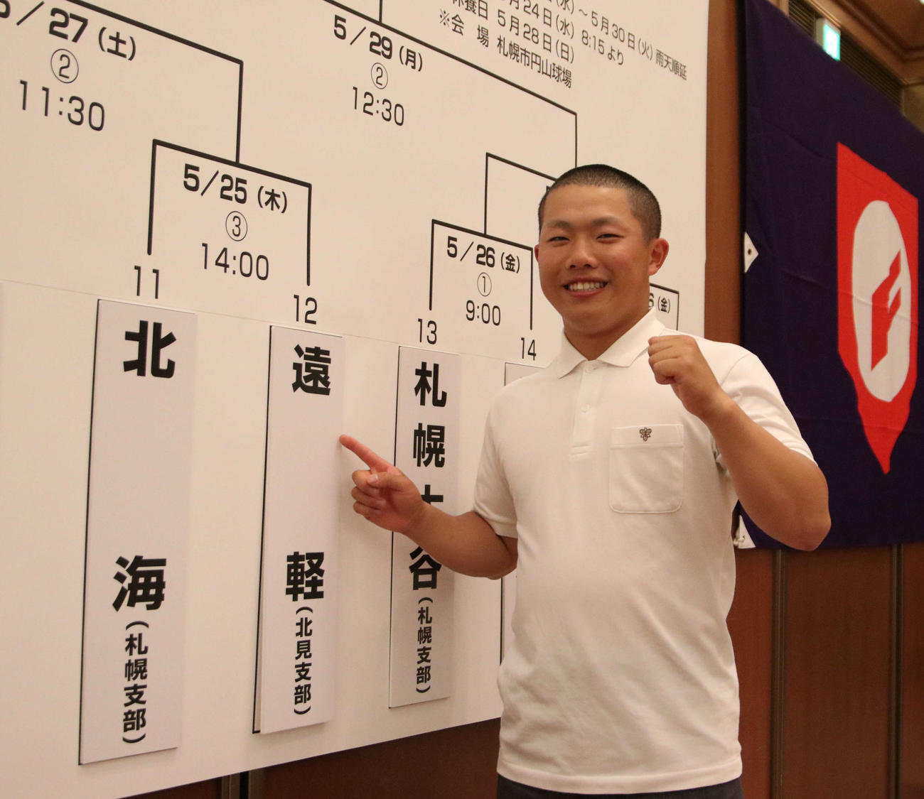 抽選が決まり学校名を指さす遠軽・小野主将（撮影・山崎純一）