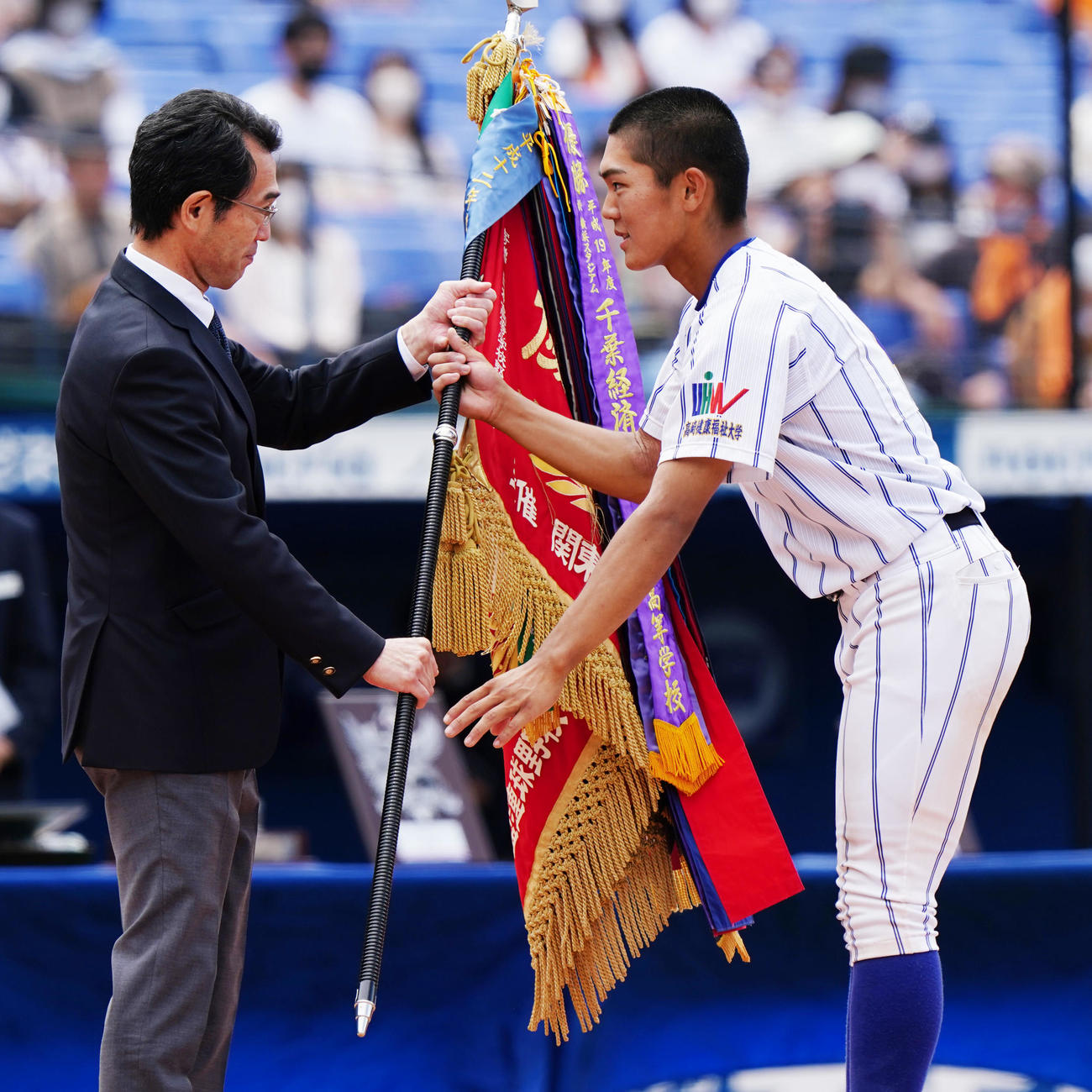 木更津総合対高崎健康福祉大高崎　閉会式で優勝旗を受け取る高崎健康福祉大高崎・森田（右）（撮影・江口和貴）